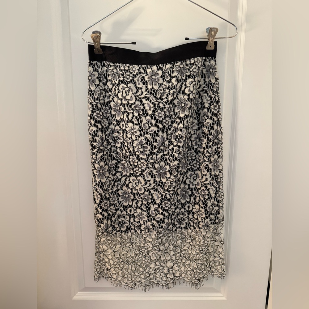 Express black and white lace midi length pencil skirt. Zip closure in back.